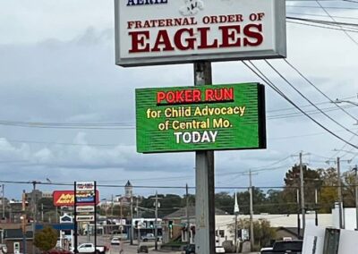 A digital sign hanging below a sign for the Eagles shows CACCMO present.