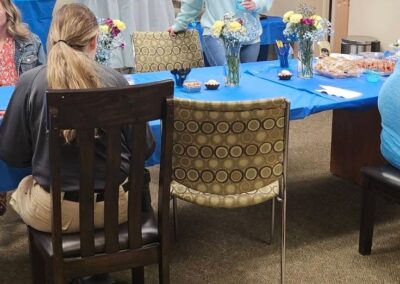 A past event shows a table adorned with a bright blue tablecloth and flower arrangements.