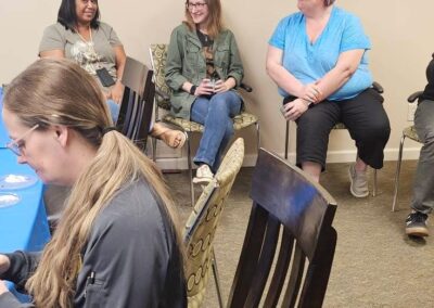 Adults gather to chat during a past event.